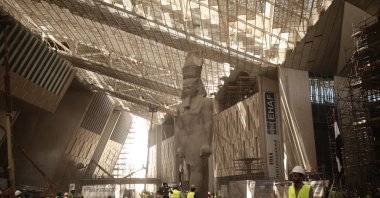 Construction workers and journalists gather at the Grand Egyptian Museum under construction in Giza, near Cairo, Egypt, Aug. 4, 2019. (AP Photo)