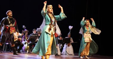 The TÜRKSOY folk orchestra performs a show as part of Nevruz celebrations at Uşak University, in the namesake western Turkish province, March 17, 2022. (AA Photo)