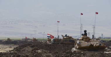 Turkish and Iraqi soldiers sit on Turkish tanks during exercises in Silopi, near the Habur border gate with Iraq, southeastern Turkey, Sept. 26, 2017. (DHA-Depo Photos via AP)