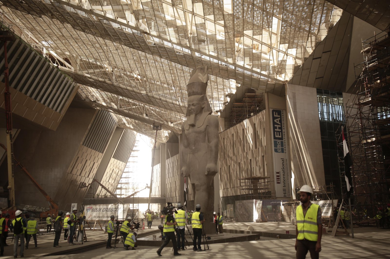Construction workers and journalists gather at                      the Grand Egyptian Museum under construction in                      Giza, near Cairo, Egypt, Aug. 4, 2019. (AP Photo)