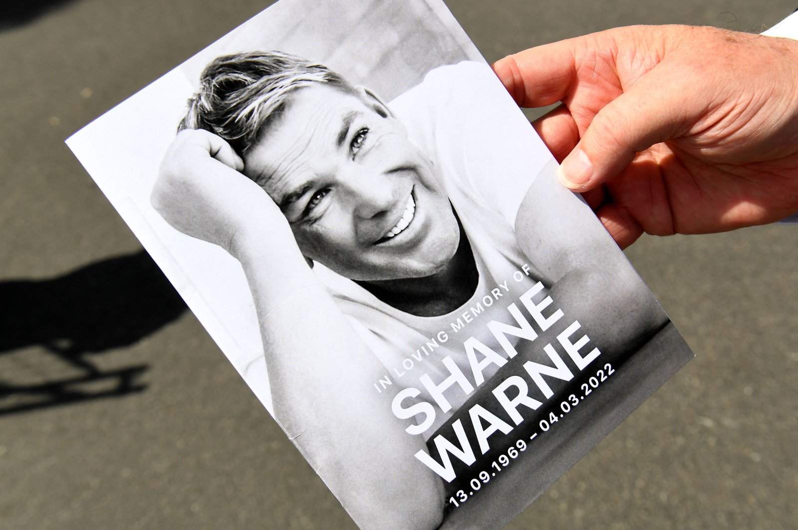 A memorial card from Australian cricket great Shane Warne&#039;s funeral, Melbourne, Australia, March 20, 2022. (AFP Photo)