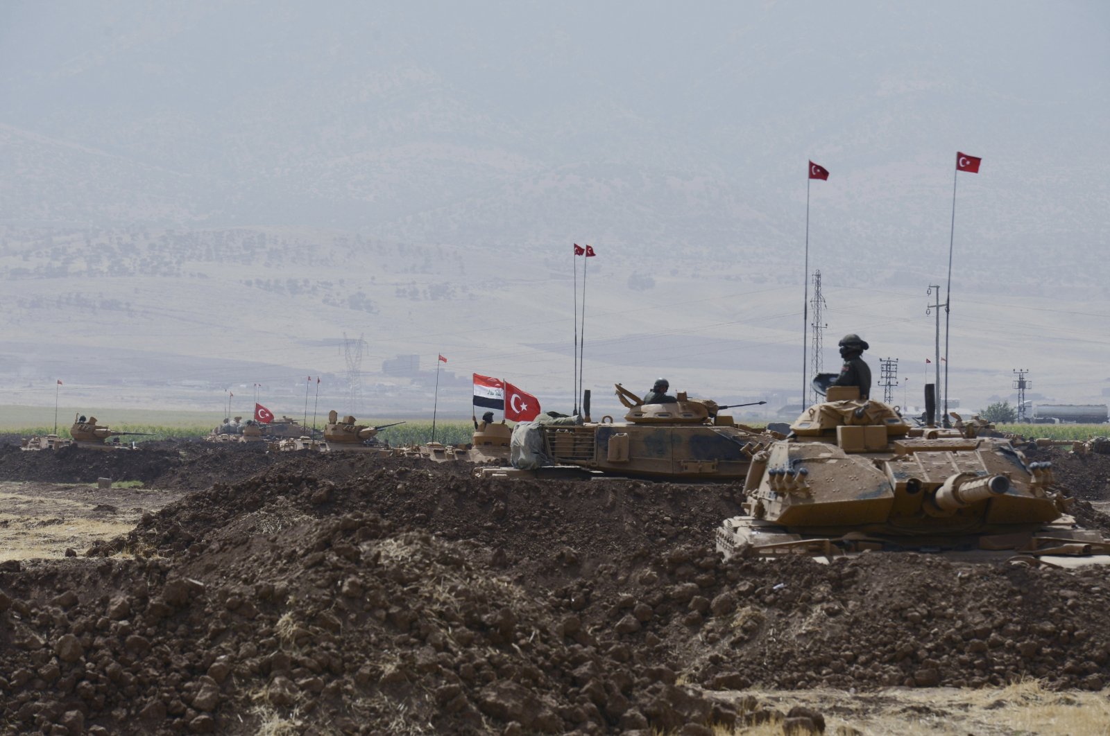 Turkish and Iraqi soldiers sit on Turkish tanks during exercises in Silopi, near the Habur border gate with Iraq, southeastern Turkey, Sept. 26, 2017. (DHA-Depo Photos via AP)