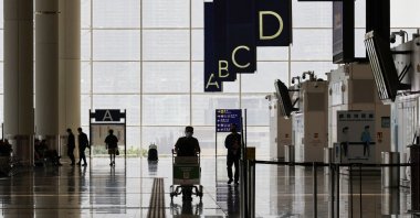 A traveler walks in the departure hall at the Hong Kong International Airport amid the COVID-19 pandemic in Hong Kong, March 21, 2022. (Reuters Photo)