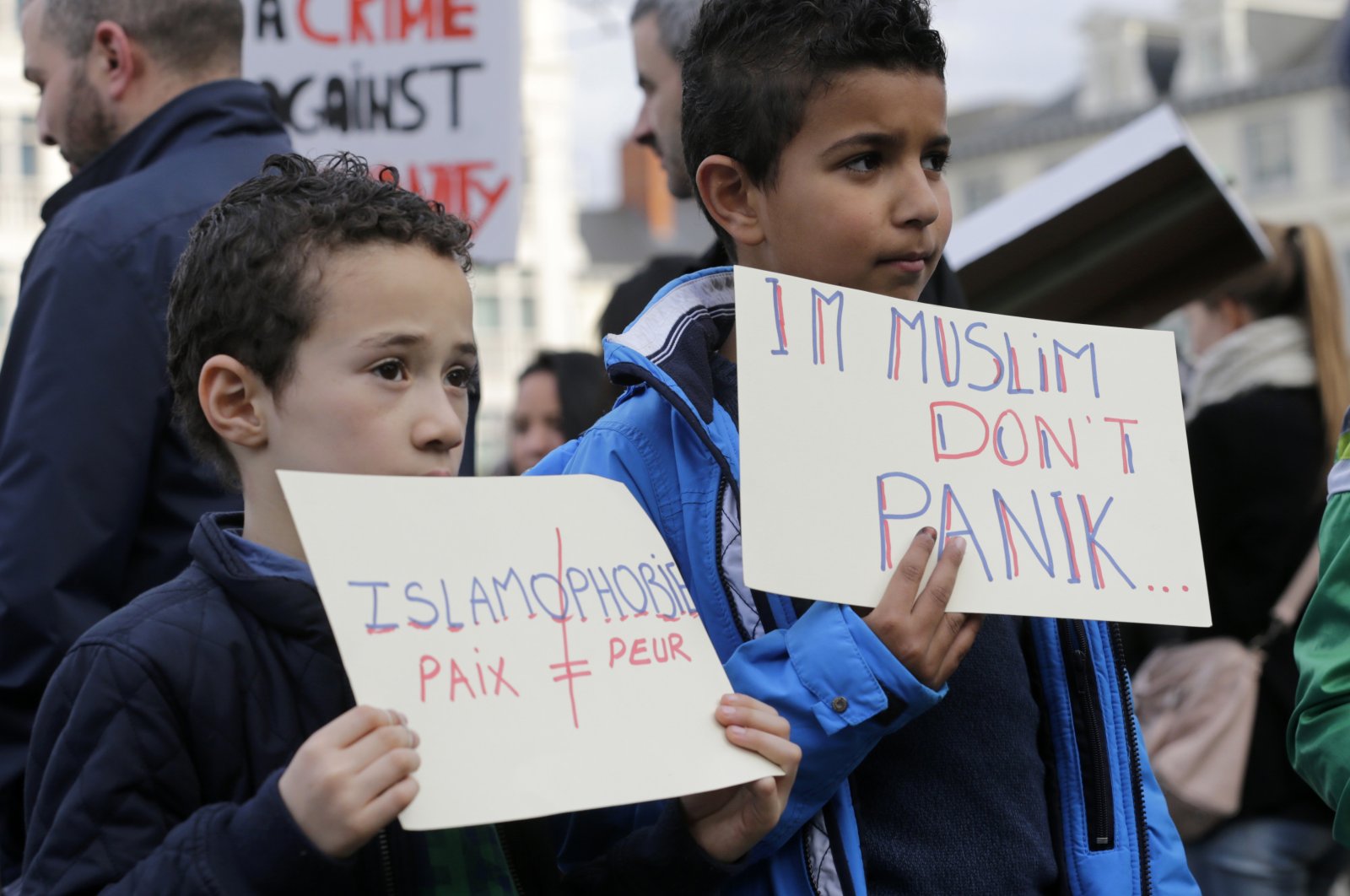 Two boys show signs during a protest against Islamophobia in Brussels, Sunday, Oct. 26, 2014. (AP File Photo)