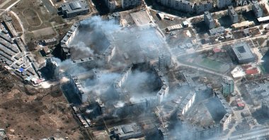 This satellite image provided by Maxar Technologies shows burning apartment buildings in northeastern Mariupol, Ukraine during the Russian invasion, March 19, 2022. (Maxar Technologies via AP)