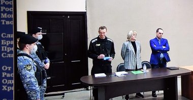 Russian opposition leader Alexei Navalny is seen on a screen via a video link during the verdict in his embezzlement and contempt of court trial at the IK-2 prison colony in the town of Pokrov in the Vladimir region, Russia, March 22, 2022. (AFP Photo)