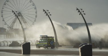 A beach patrol vehicle drives past waves crashing against the breakwater as storm Eleanor hits the coastline in Blackpool, northwest England, U.K., Jan. 3, 2018. (EPA-EFE Photo)