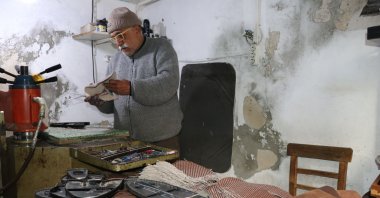 Süleyman Küçükgöz, a shoe or &quot;upper maker,&quot; works in his shop, in Adana, southern Turkey, March 22, 2022. (AA Photo)