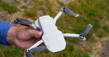 Ralph Werner of Quadrocopter Flight School holds a drone, a DJI Mavic Mini, in a park. (Reuters File Photo)