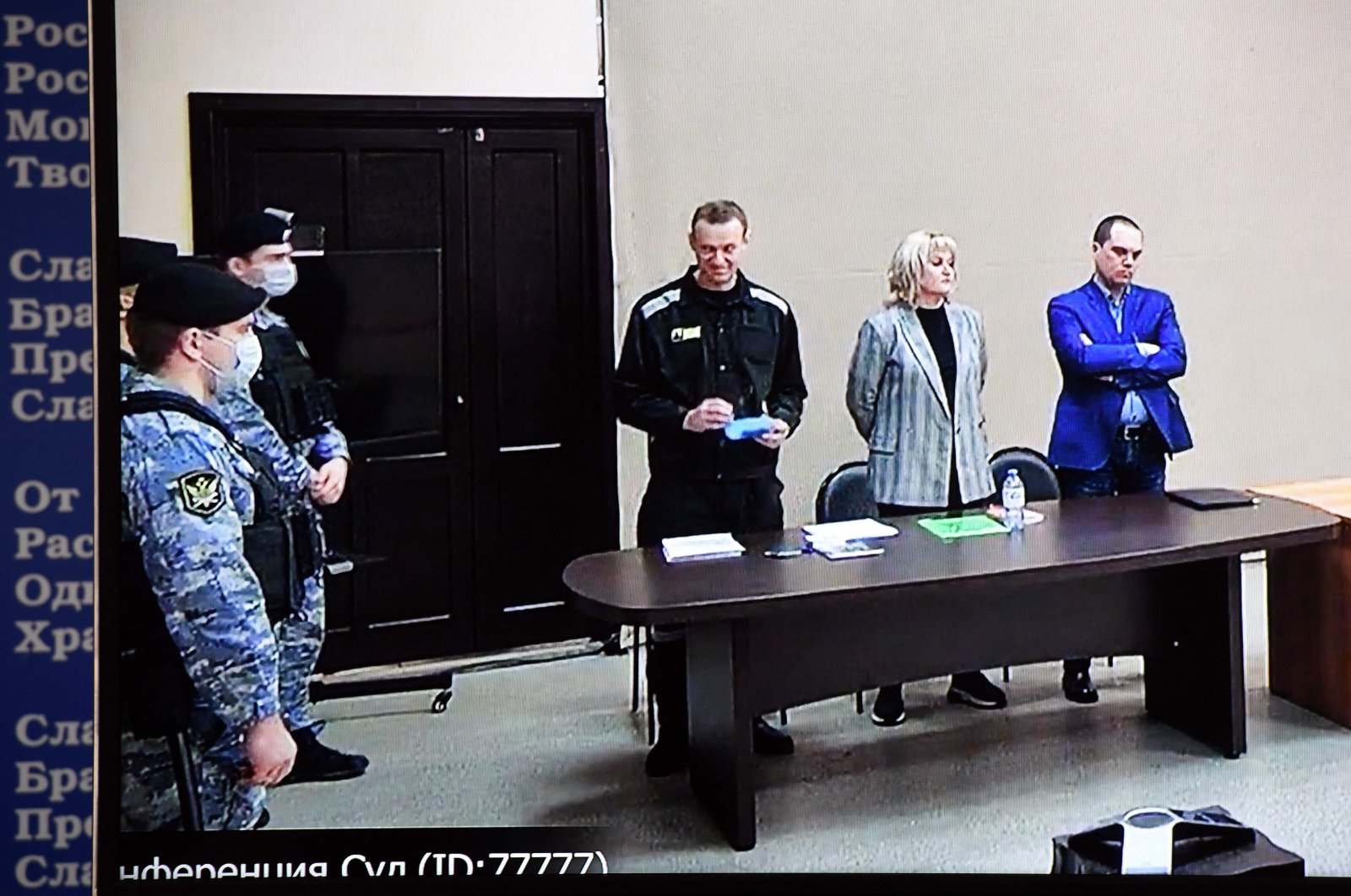 Russian opposition leader Alexei Navalny is seen on a screen via a video link during the verdict in his embezzlement and contempt of court trial at the IK-2 prison colony in the town of Pokrov in the Vladimir region, Russia, March 22, 2022. (AFP Photo)