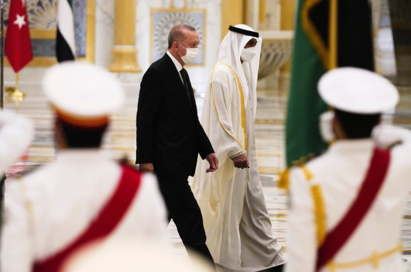 President Recep Tayyip Erdoğan (L) and Abu Dhabi Crown Prince Sheikh Mohammed bin Zayed Al Nahyan look over an honor guard at Qasr Al Watan in Abu Dhabi, United Arab Emirates, Feb. 14, 2022. (AP Photo)