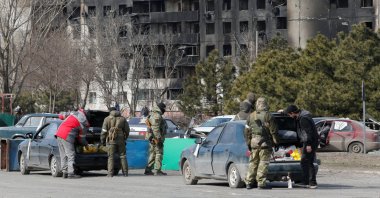 Service members of pro-Russian troops check cars during Ukraine-Russia conflict in the besieged southern port city of Mariupol, Ukraine, March 20, 2022. (Reuters Photo)