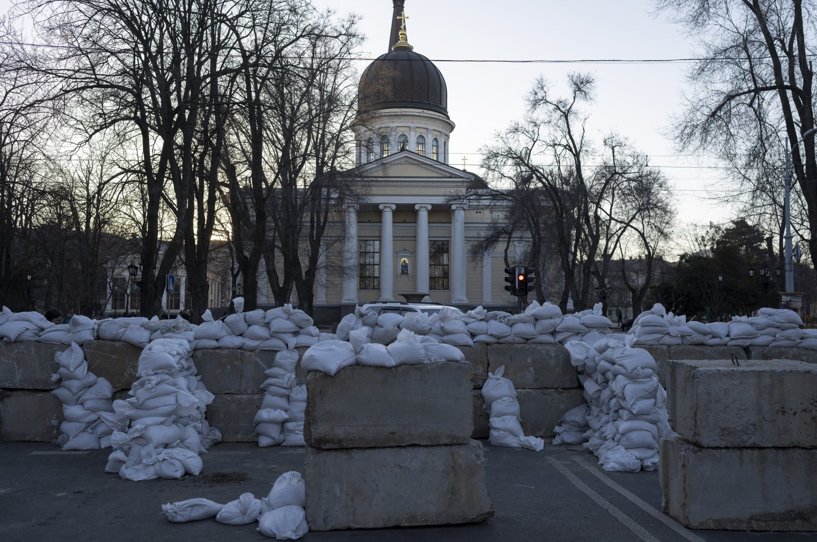 Concrete blocks topped with sandbags block a street in Odesa, southern Ukraine, as at the background is stands the Preobrazhensky Cathedral, on Tuesday, March 22, 2022.(AP Photo/Petros Giannakouris)