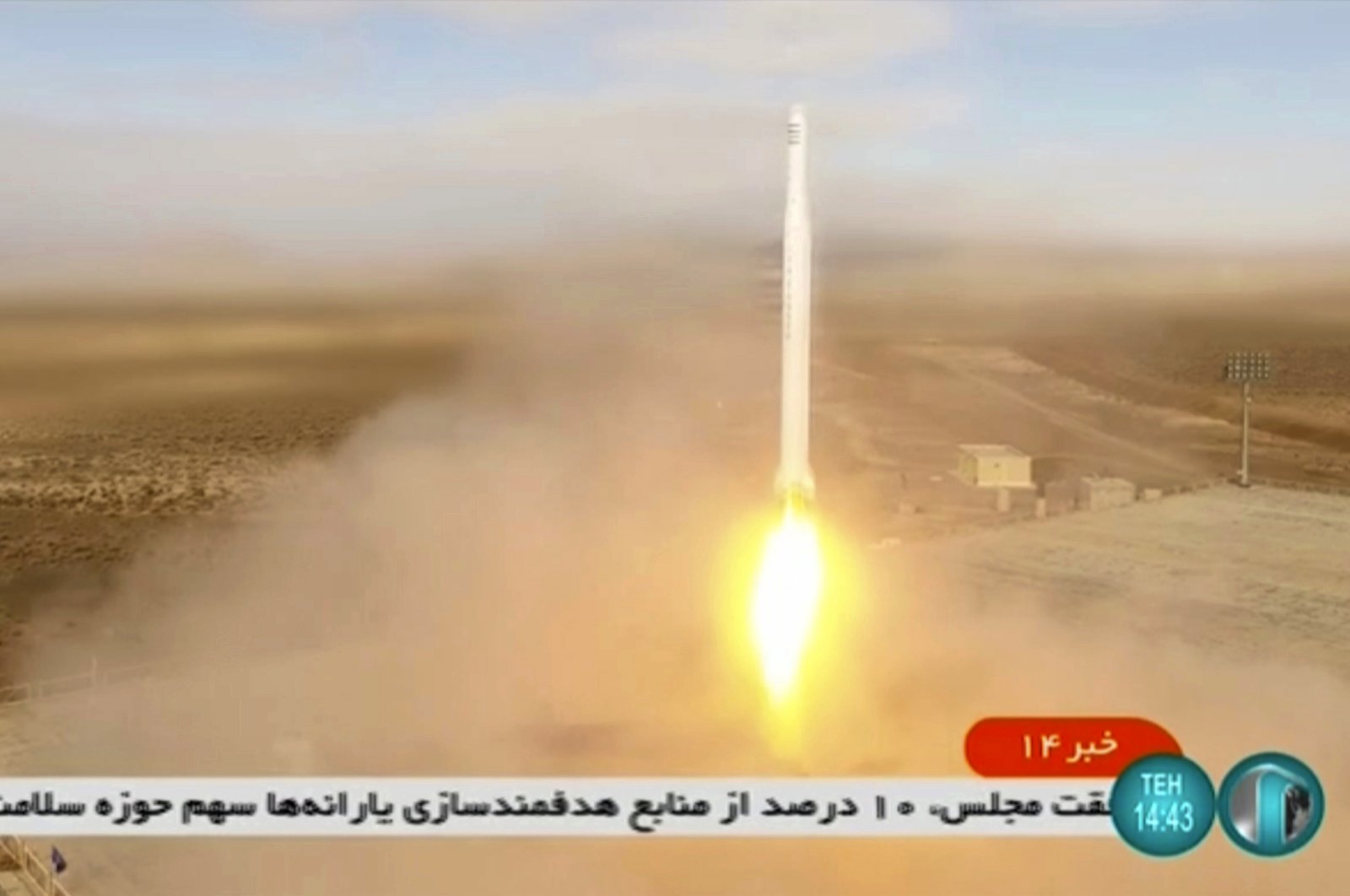The launch of a rocket by Iran's Revolutionary Guard carrying a Noor-2 satellite is seen in the Shahroud Desert in Iran in this image taken from video footage aired by Iranian state television on March 8, 2022. (Iranian state television via AP)