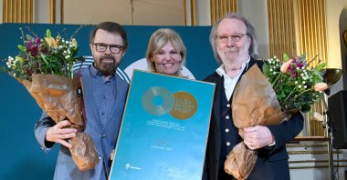 Members of Swedish disco group ABBA Bjorn Ulvaeus (L) and Benny Andersson (R) pose for a picture as they are awarded by Minister for Foreign Trade and Nordic Affairs Anna Hallberg (C) of the Swedish Government’s Music Export Prize 2021 in Stockholm, Sweden, March 23 2022. (AFP)