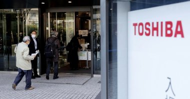 People enter the building where Toshiba Corp. held its extraordinary shareholders’ meeting in Tokyo, Japan, March 24, 2022. (Kyodo News via AP)
