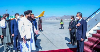 Taliban Foreign Minister Amir Khan Muttaqi (L) greets China's Foreign Minister Wang Yi (R) upon his arrival at Kabul airport, Afghanistan, March 24, 2022. (Taliban Foreign Ministry via AFP)