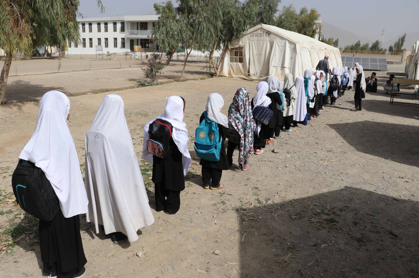 Afghan girls of up to primary grades line up at their school in Kandahar, Afghanistan, March 23, 2022.  (EPA Photo)