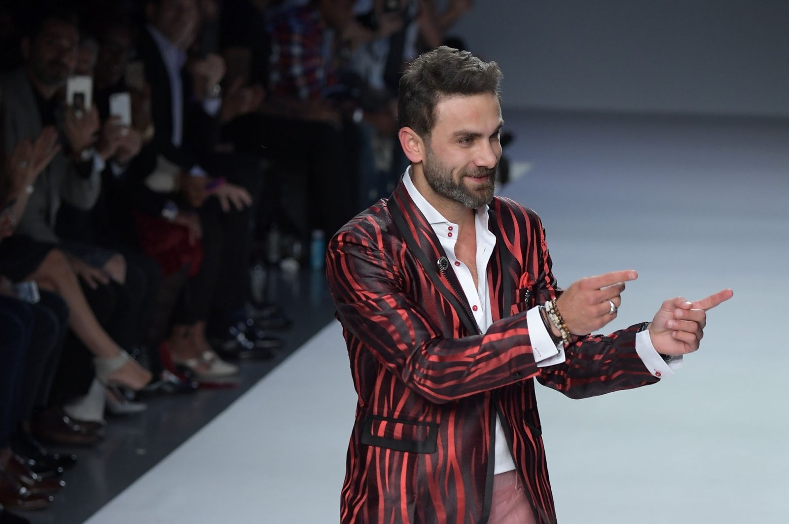 Designer Peyman Umay greets the audience after a fashion show during New York Fashion Week, New York, U.S., Sept. 7, 2017. (Shutterstock Photo)
