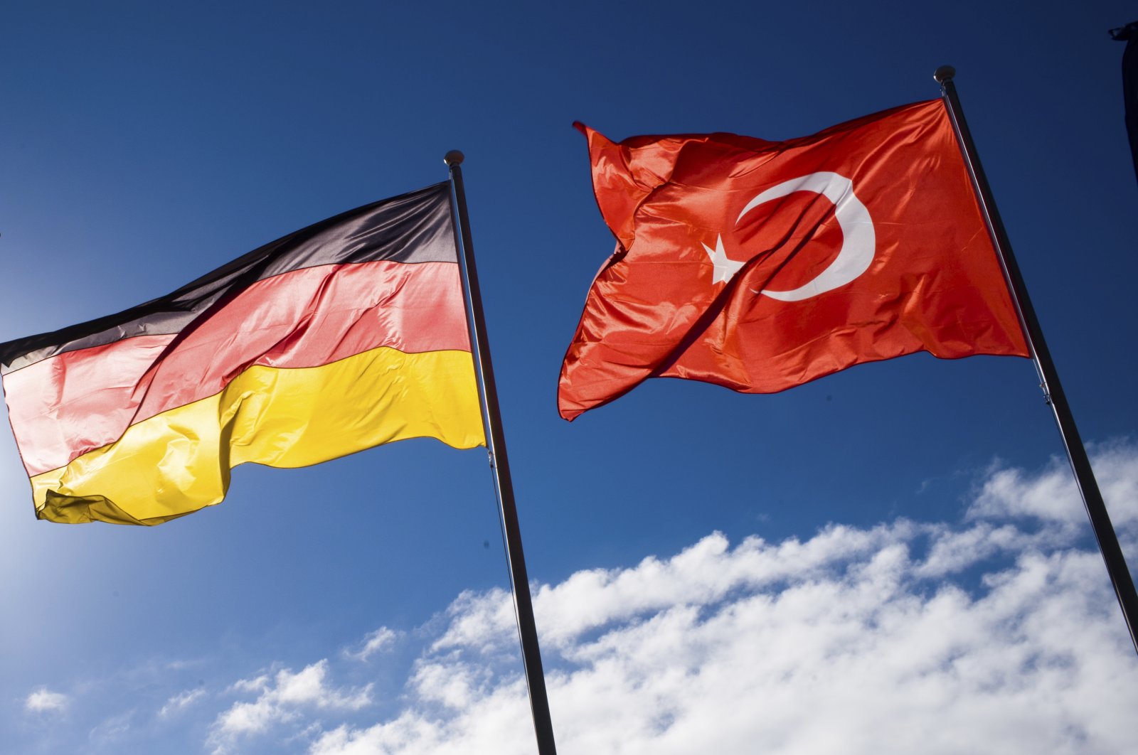 A German and Turkish flag wave at the Tegel airport prior to the arrival of President Recep Tayyip Erdoğan for an official state visit in Germany at the capital Berlin, Thursday, Sept. 27, 2018. (AP File Photo)