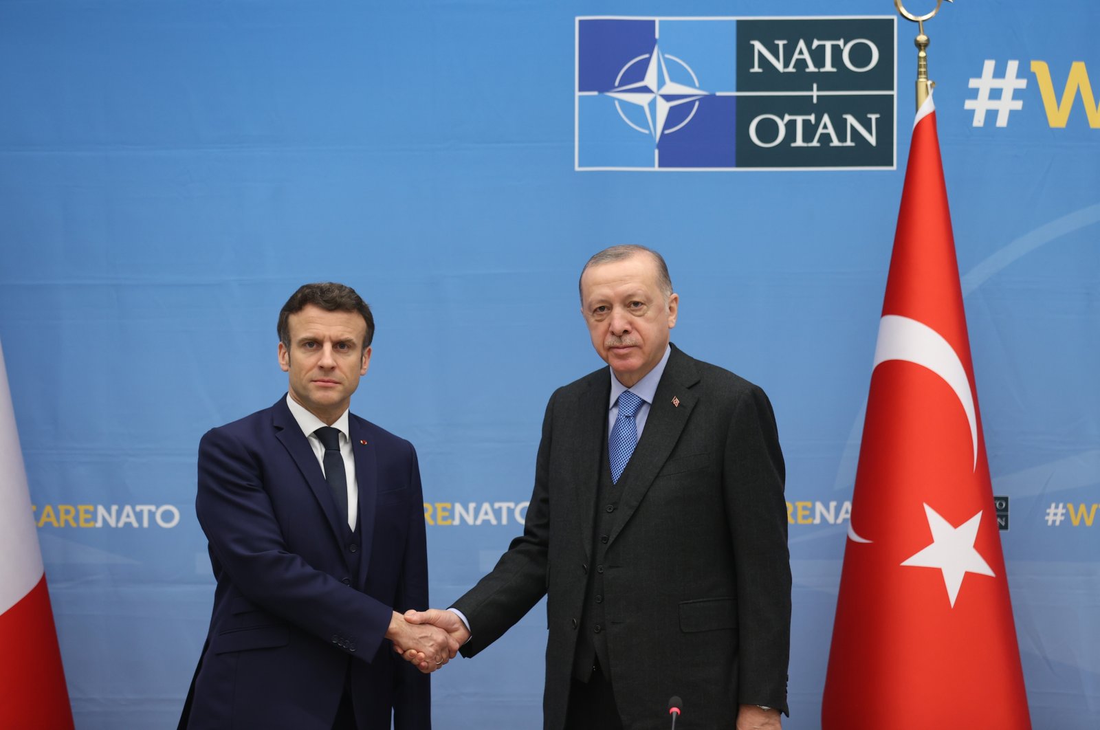 French President Emmanuel Macron, left, and his Turkish counterpart Recep Tayyip Erdoğan shake hands as they attend a bilateral meeting ahead of a NATO summit to discuss Russia&#039;s invasion of Ukraine, at the NATO headquarters in Brussels, Belgium on Mar. 24, 2022. (IHA Photo)