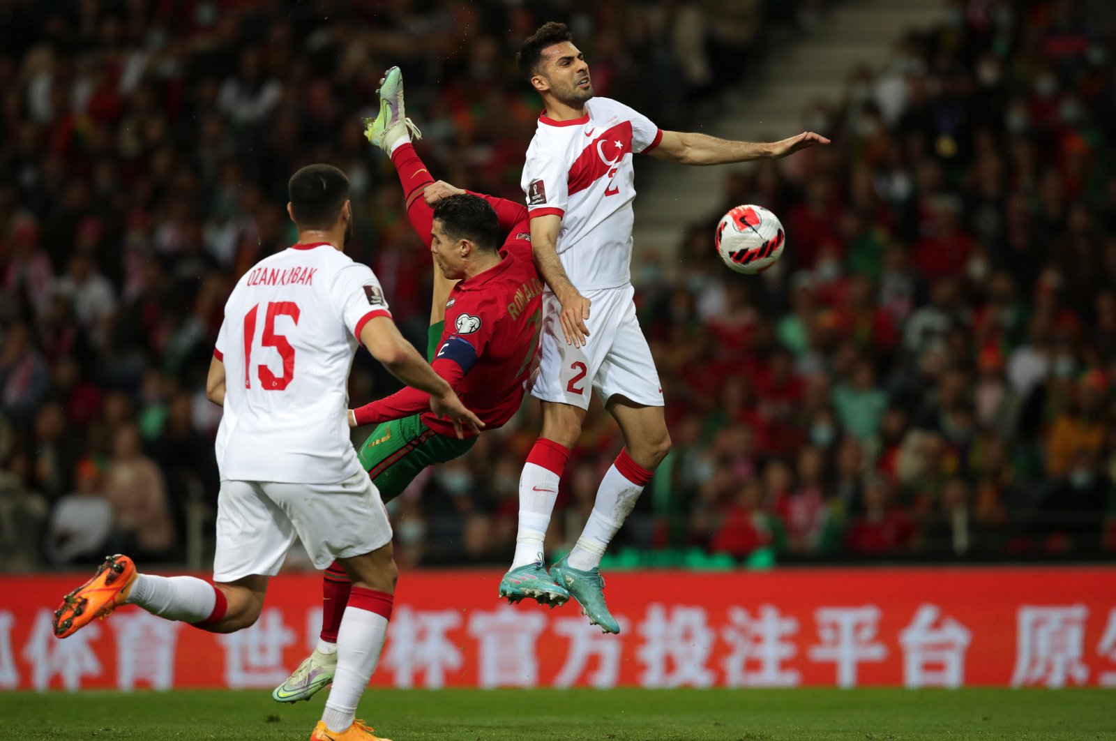 Portugal players Cristiano Ronaldo (C) in action against Turkey players Ozan Kabak (L) and Zeki Çelik during the FIFA World Cup Qatar 2022 play-off qualifying soccer match between Portugal and Turkey held on Dragao stadium in Porto, Portugal, 24 March 2022. (EPA Photo)