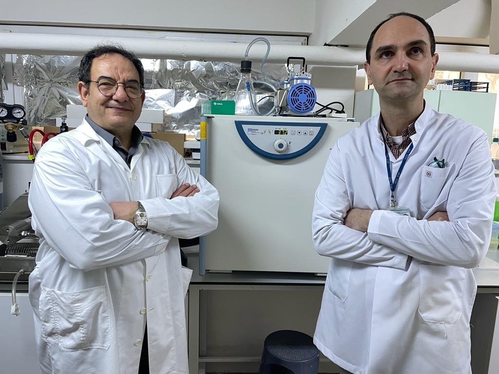 Professor Adnan Yüksel Gürüz (L) and associate professor Mert Döşkaya, a developer of the vaccine, pose in the lab, in Izmir, western Turkey, March 24, 2022. (AA Photo)