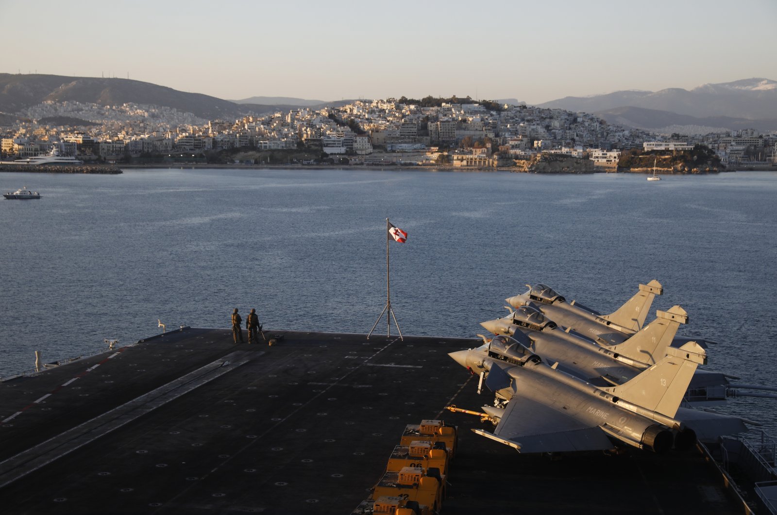 French Navy Rafale fighter jets stand parked onboard the Charles de Gaulle aircraft carrier, off the shore of the Faliro suburb, Athens, Greece, March 24, 2022. (AP Photo)
