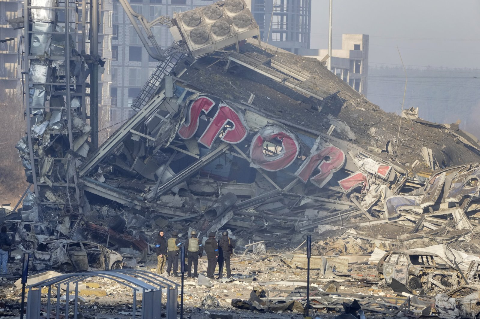 People examine the damage after shelling of a shopping center, in Kyiv, Ukraine, March 21, 2022. (AP Photo)