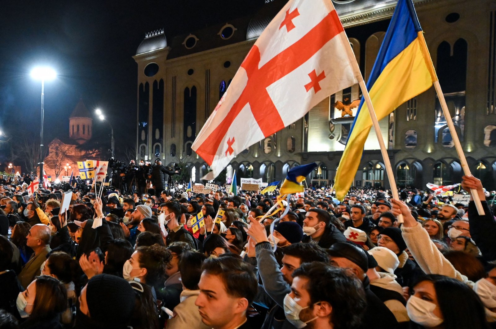 Demonstrators hold placards and wave flags during a rally in support of Ukraine in Tbilisi, Georgia, March 1, 2022. (AFP Photo)