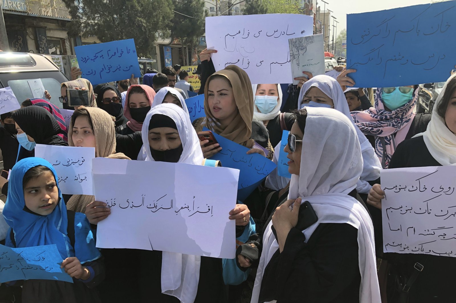 Afghan women chant and hold signs of protest during a demonstration in Kabul, Afghanistan, Saturday, March 26, 2022. (AP Photo)