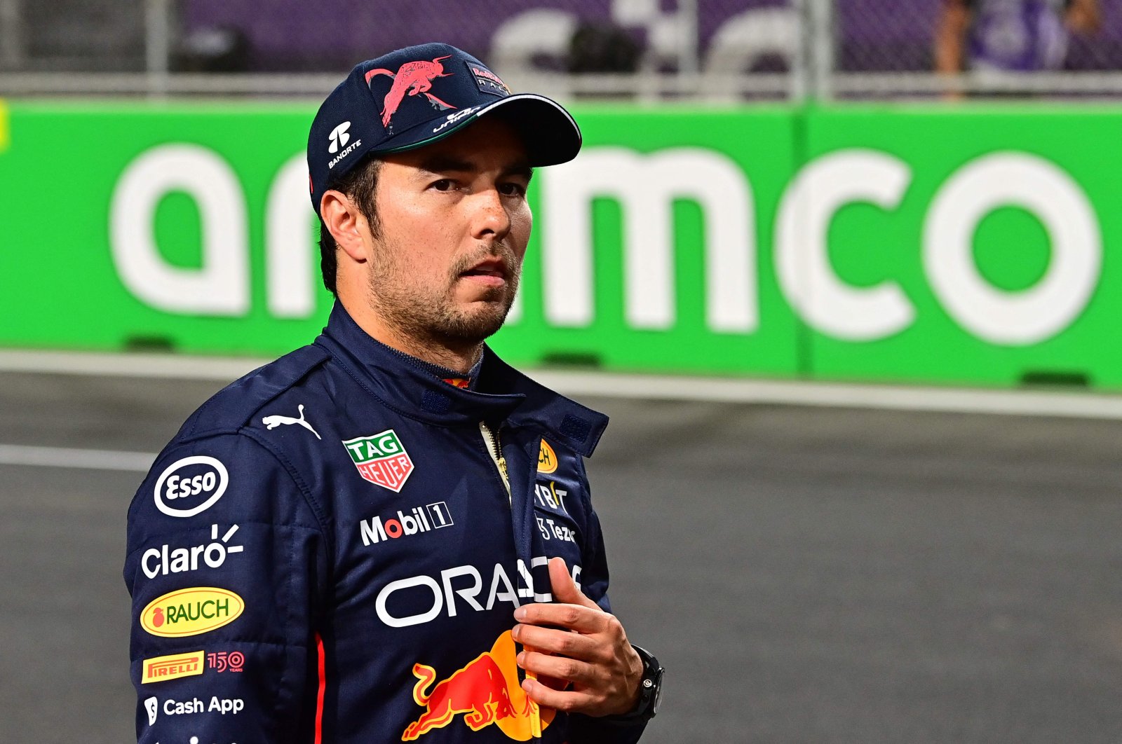 Red Bull&#039;s Mexican driver Sergio Perez walks on the grid after the qualifying session on the eve of the 2022 Saudi Arabia Formula One Grand Prix at the Jeddah Corniche Circuit, Suadi Arabia, March 26, 2022. (AFP Photo)