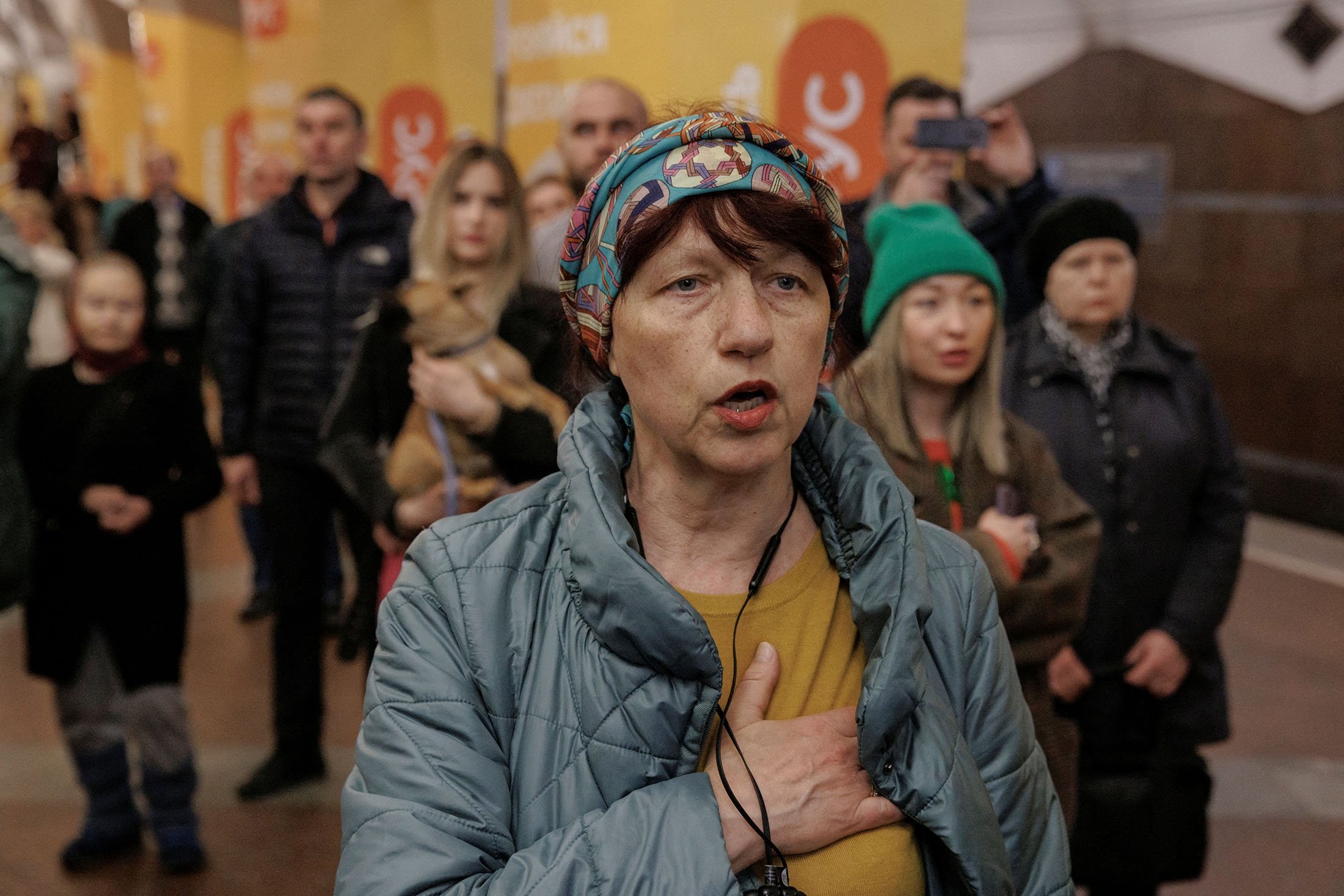 People sing the Ukrainian national anthem during a classical music concert performed by local musicians at a metro station that serves as a bomb shelter as the Russian attack on Ukraine continues in Kharkiv, Ukraine Ukraine, March 26, 2022. (Photo Reuters)