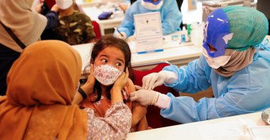 A girl reacts while receiving her second dose of China's Sinovac Biotech vaccine during a mass vaccination program against COVID-19 for children aged 6 to 11 in Jakarta, Indonesia, Jan. 16, 2022. (Reuters Photo)