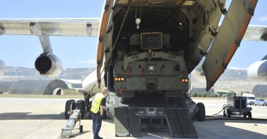 Military officials work around a Russian transport aircraft, carrying parts of the S-400 air defense systems, after it landed at Mürted military airport outside Ankara, Turkey, Aug. 27, 2019. (AP Photo)