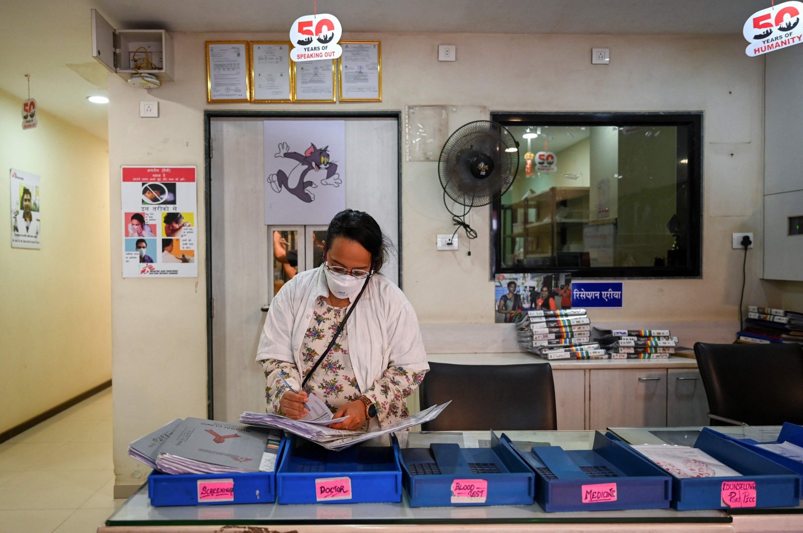 A doctor goes through medical files at a Doctors Without Borders (MSF) clinic that treats people with drug-resistant tuberculosis in Mumbai, India, March 22, 2022. (AFP Photo)