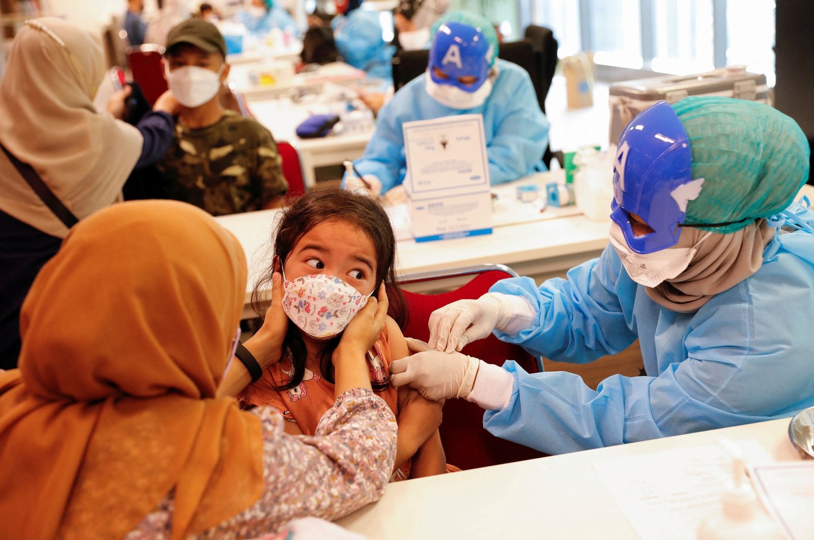 A girl reacts while receiving her second dose of China&#039;s Sinovac Biotech vaccine during a mass vaccination program against COVID-19 for children aged 6 to 11 in Jakarta, Indonesia, Jan. 16, 2022. (Reuters Photo)