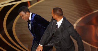 Will Smith (R) hits Chris Rock as Rock spoke on stage during the 94th Academy Awards in Hollywood, Los Angeles, California, U.S., March 27, 2022. (Reuters Photo)