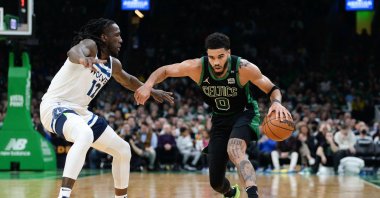 Celtics' Jayson Tatum (R) dribbles against the Timberwolves' Taurean Prince in an NBA game, Boston, Massachusetts, March 27, 2022. (AFP Photo)