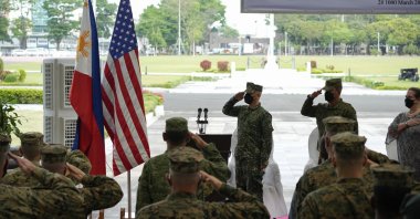Philippine and U.S. soldiers salute to their flags as the national anthem is played during opening ceremonies of the &quot;Balikatan&quot; or &quot;Shoulder to Shoulder&quot; joint military exercises at Camp Aguinaldo, Quezon City, Philippines, March 28, 2022. (AP Photo)