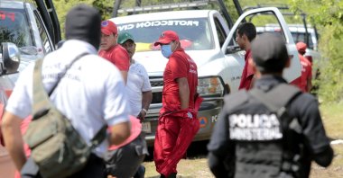 Mexican police officers and members of the civil protection remain in the site where a mass grave was found in Pueblo Viejo, in the outskirts of Iguala, Guerrero state, Mexico, Oct. 5, 2014. (AFP Photo)