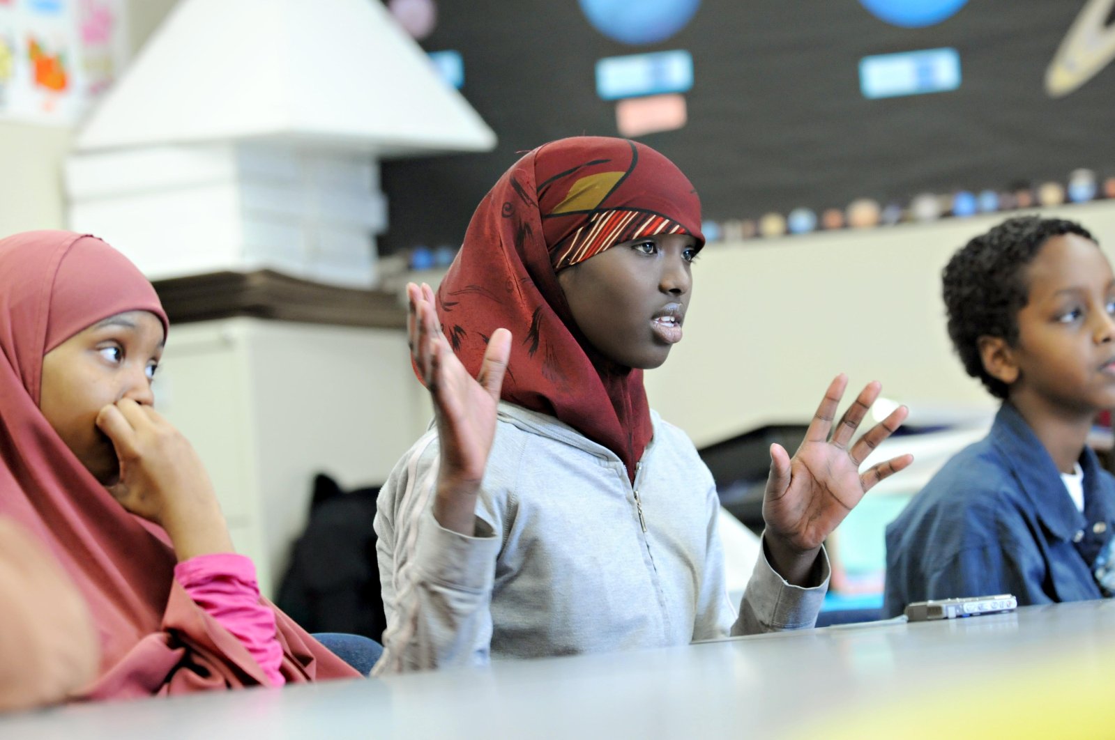 Fartun Arale, center, shares stories about her family, Somali culture and history with her classmates Halima Jama, 13, left, and Mohamud Mohamed at MInnesota International Middle School in Minneapolis, a charter school that enrolls mostly East African students, Jan. 6, 2010. (AP File Photo)