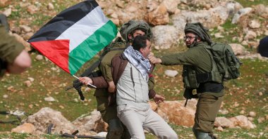A Palestinian demonstrator is detained by Israeli soldiers during a demonstration against then-U.S. President Donald Trump's peace proposals, near the West Bank village of Tubas, near the Jordan Valley, Jordan, Jan. 29, 2020. (AFP Photo)