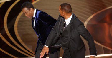 Will Smith (R) hits Chris Rock as Rock spoke on stage during the 94th Academy Awards in Hollywood, Los Angeles, California, U.S., March 27, 2022. (Reuters Photo)