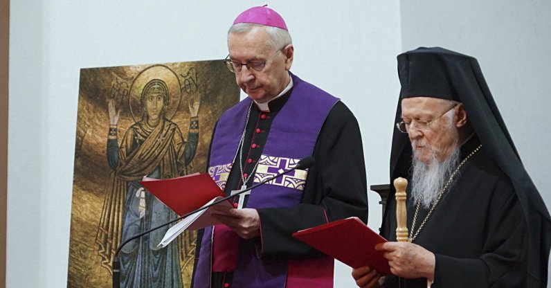 Patriarch Bartholomew I, (R) and Archbishop Stanisław Gądecki, the head of the Polish Bishops&#039; Conference, stand together as they meet with Ukrainian refugees in Warsaw, Poland, March 29, 2022. (AP)