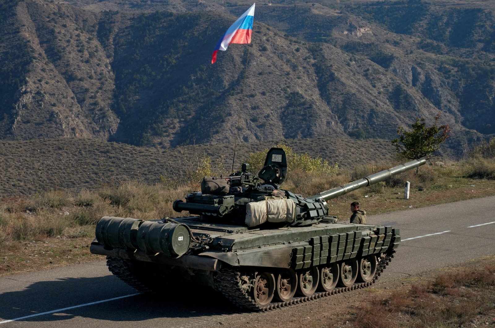 A member of the Russian peacekeeping troops stands next to a tank near the border with Armenia in the region of Nagorno-Karabakh, Azerbaijan, Nov. 10, 2020. (REUTERS Photo)