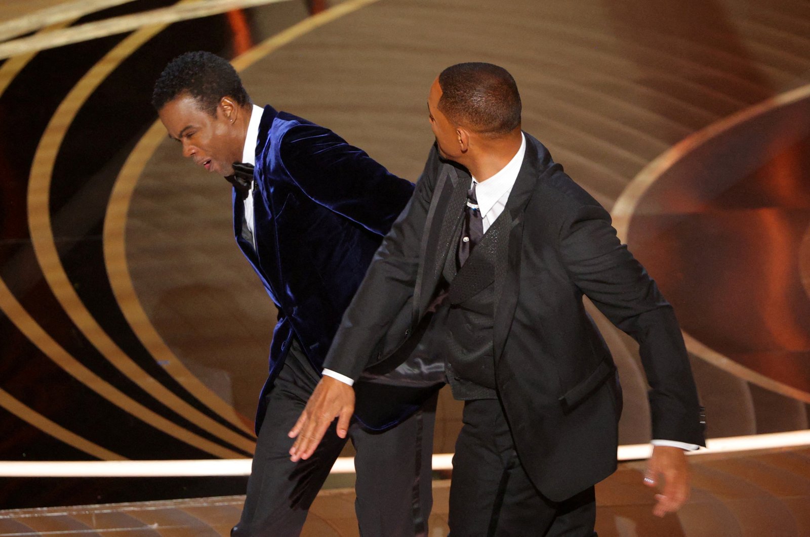 Will Smith (R) hits Chris Rock as Rock spoke on stage during the 94th Academy Awards in Hollywood, Los Angeles, California, U.S., March 27, 2022. (Reuters Photo)