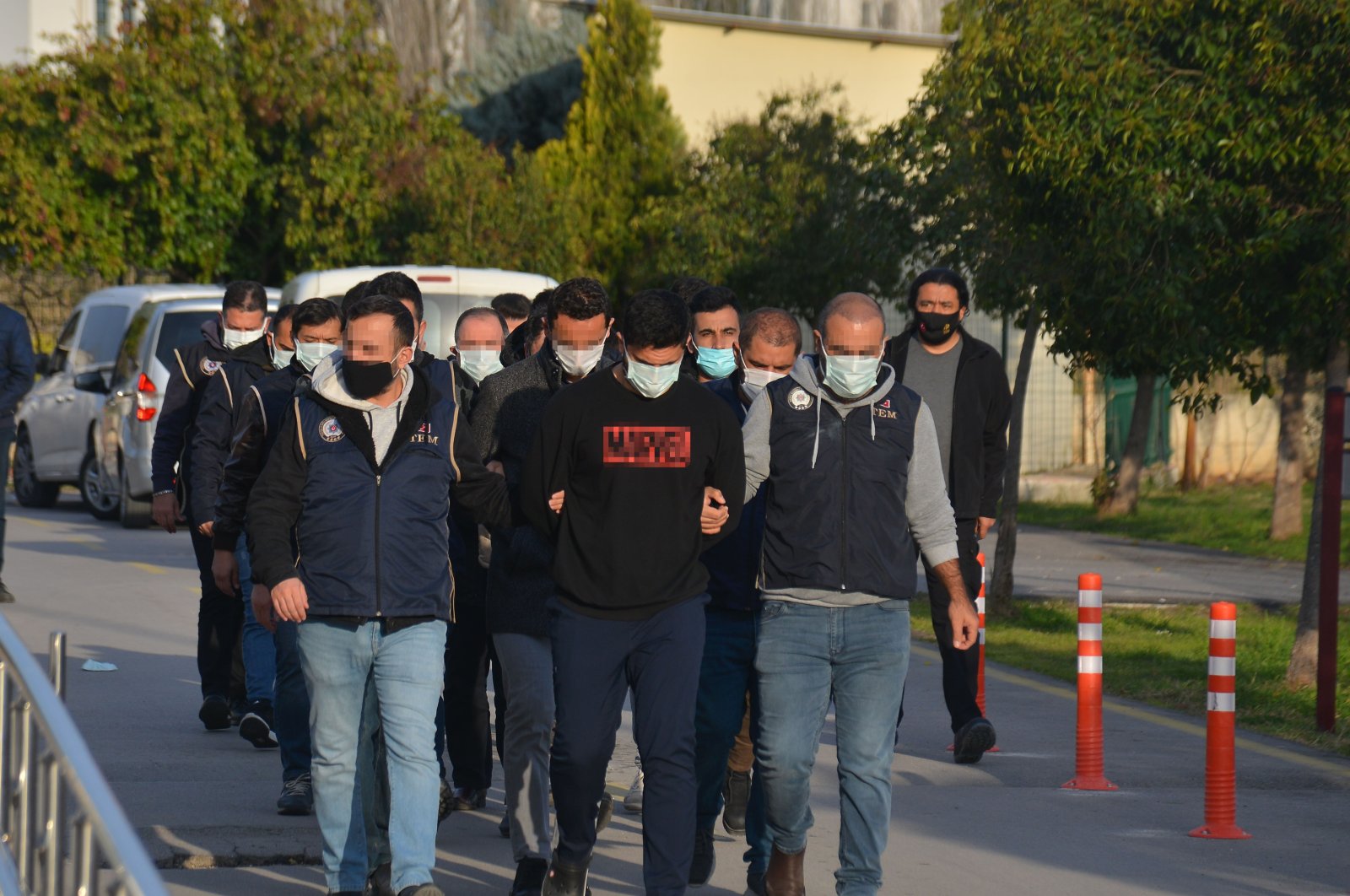 Police officers escort captured FETÖ suspects, in Adana, southern Turkey, March 29, 2022. (DHA PHOTO)