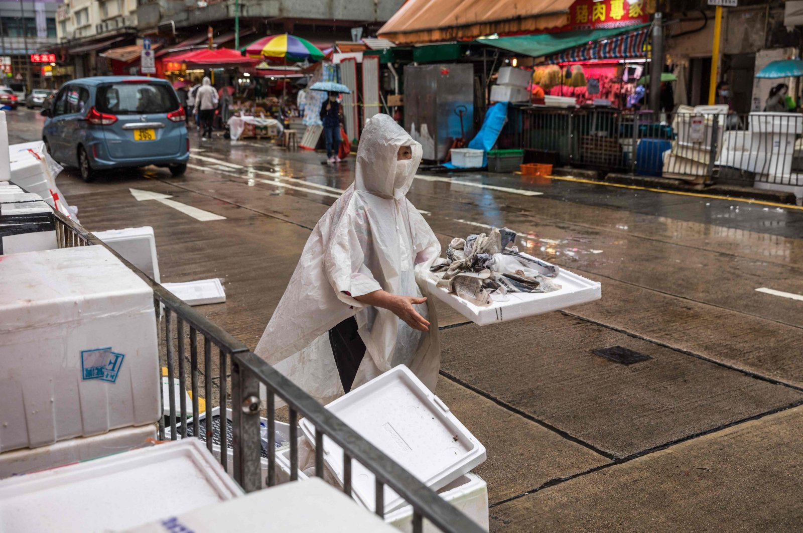 A woman stacks boxes at a fresh food market in Hong Kong, China, March 28, 2022. (AFP Photo)