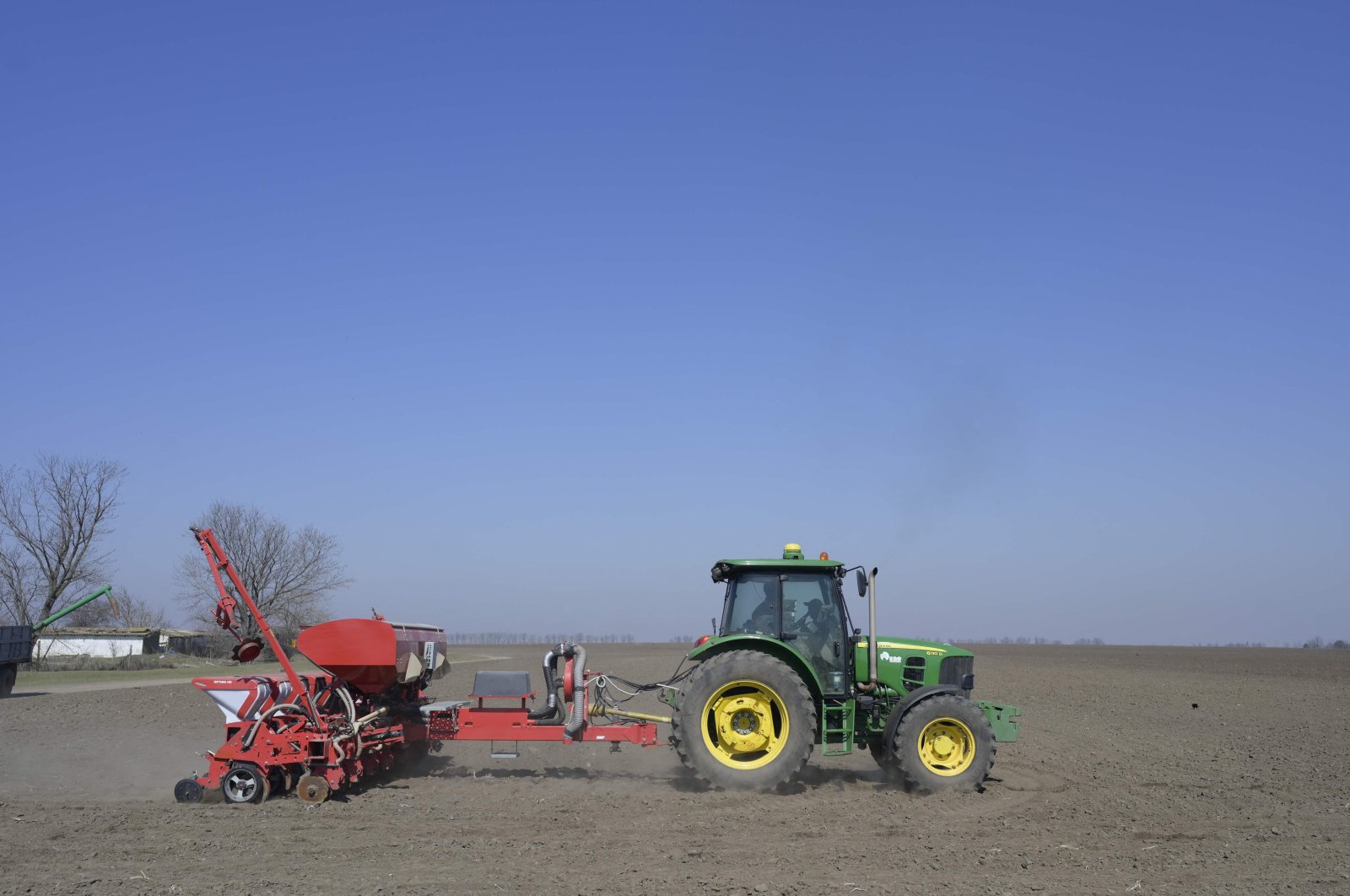 A farmer drives a tractor as he works in the field at Bogatoye village in Izmail, Ukraine, March 24, 2022. (AFP Photo)